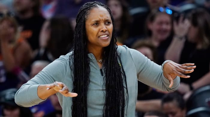 Seattle Storm head coach Noelle Quinn gives instructions to her players on the court during a game against the Phoenix Mercury.
